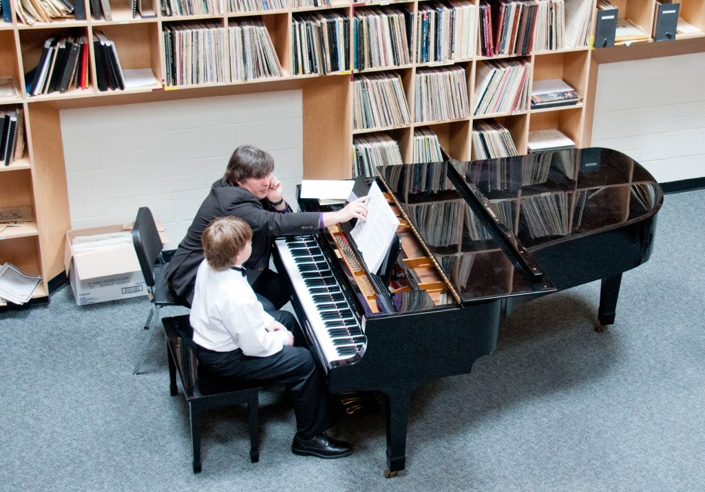 A piano student performing in a masterclass after choosing piano for their first instrument.