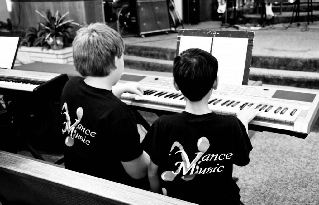 Two piano students at a workshop.