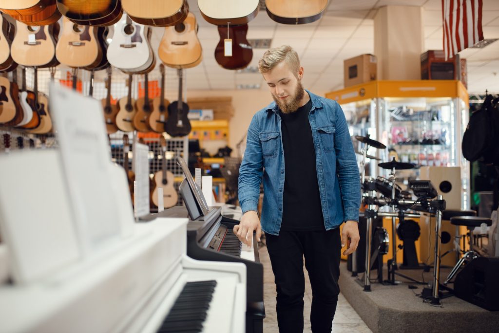 A parent shopping at a piano store